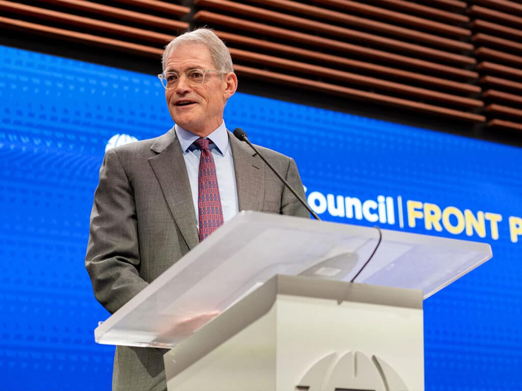 Michael Fisch speaking at an Atlantic Council Front Page event from a podium