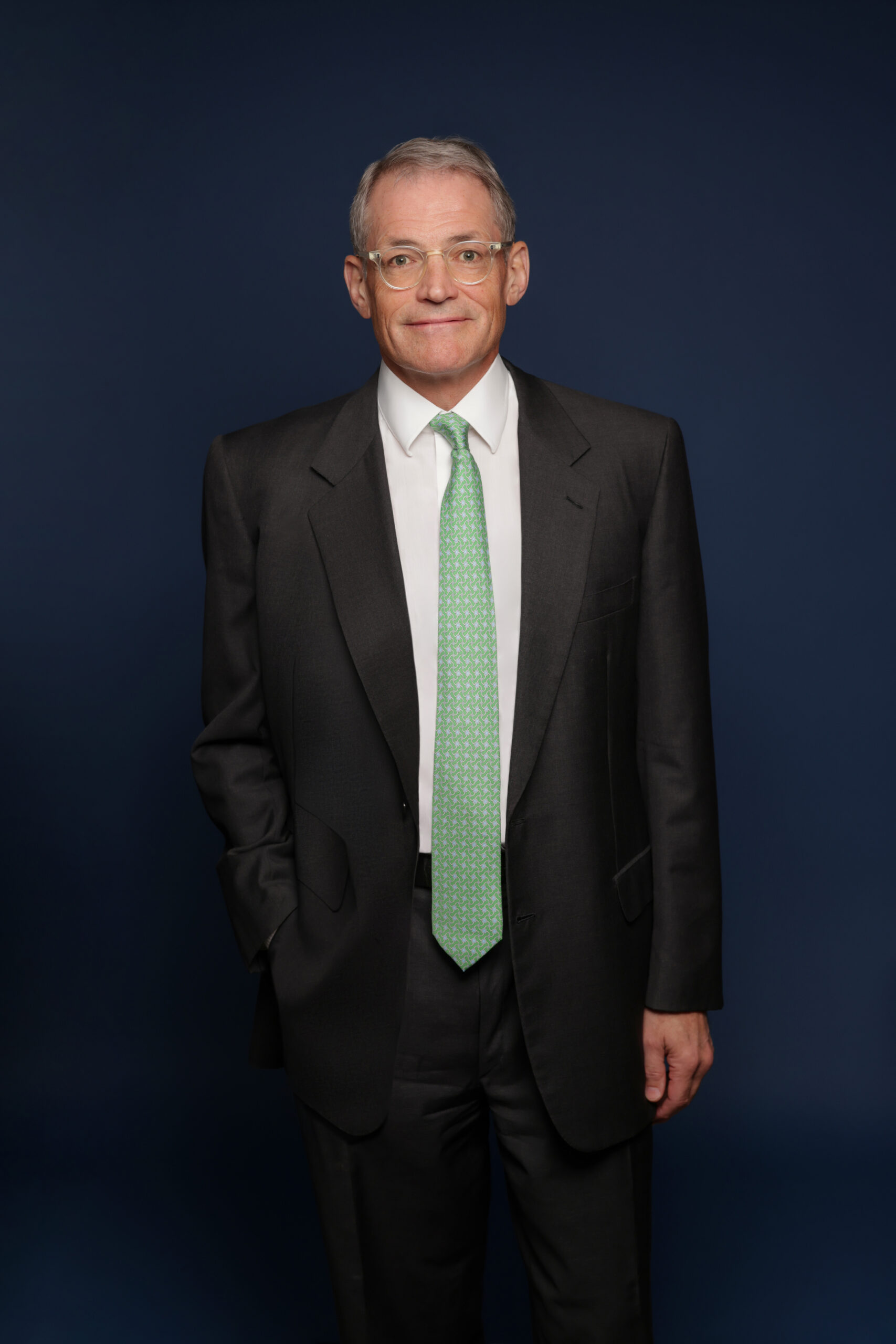 Michael Fisch, Founder and CEO of American Securities, standing in a dark suit